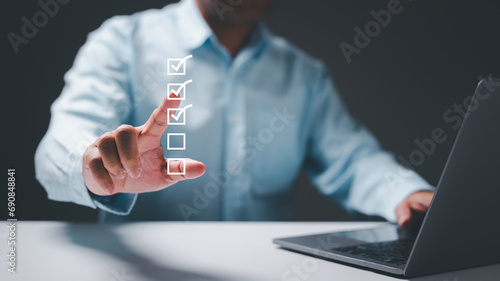 Businessman's hand confidently marks choices on his business checklist, embodying a strategic decision-making process with each checked checkbox. A visual representation of effective business planning
