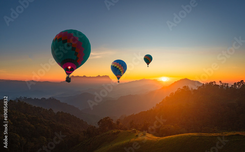 Hot air balloons flying at blue sky background - romantic landscape with two colorful balloons. Beautiful travel idea for your vacation..