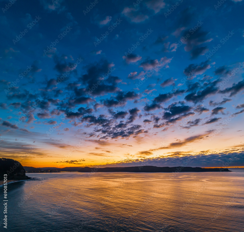 Fototapeta premium Aerial sunrise seascape with pretty cloud filled sky