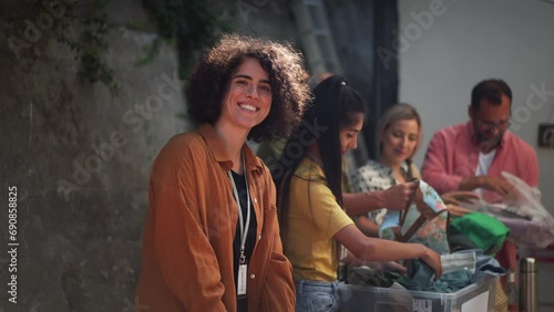 Volunteers sorting of clothes collected in a charity. Charitable work concept.