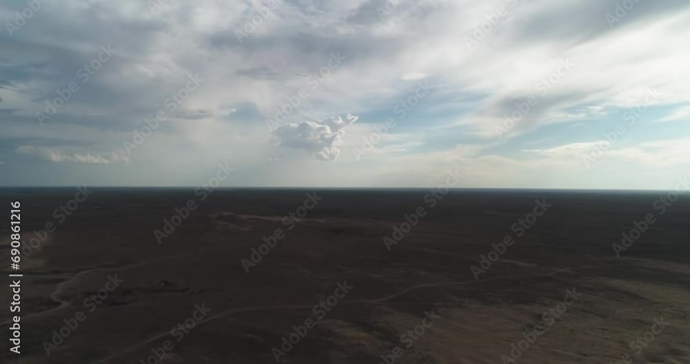 Dronn flies over the sand dunes of the desert on a cloudy day Dronn flies over the sand dunes of the desert on a cloudy day