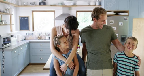 Face, hug and happy family in a kitchen laughing, bond and having fun at home together. Love, portrait and children with parents in a house for support, security or trust, playing or weekend freedom photo