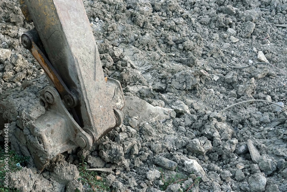 Old buckets of an excavator machine stay down on grounds in the the construction site. Old buckets of an excavator machine stay down on grounds in the the construction site.