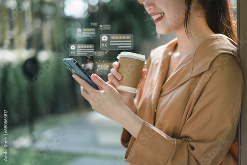 Close up of customer writing reviews, hand pressing on a smartphone screen with a golden five star rating feedback icon. Concept of rating and feedback for evaluation.