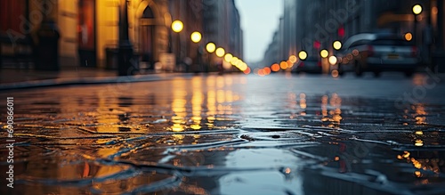 City street during rain reflects building in puddle.