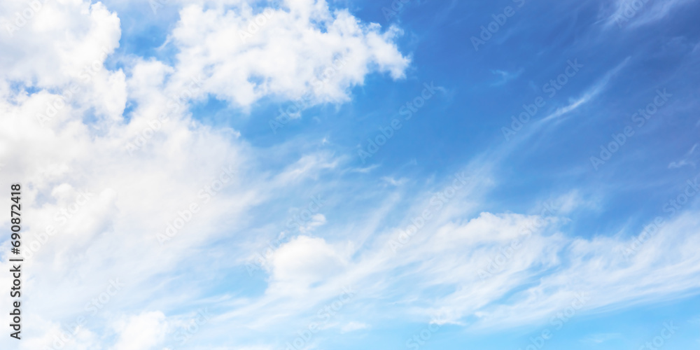 Soft and fluffy clouds formation on the bright sunny blue sky. Nature abstract background. Fresh air, weather and freedom concept. Banner for website. Soft and fluffy clouds formation on the bright sunny blue sky. Nature abstract background. Fresh air, weather and freedom concept. Banner for website.