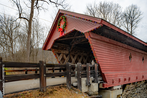 Historic timber one lane covered bridge in the Town of Newfield, Tompkins County NY with holiday lights.	 photo