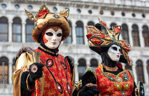 The masked couple in San Marco in Venice for the days of Mardi gras  and the Carnival photo