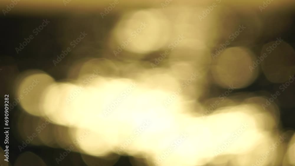 Blurred golden sea at sunset. The sun reflects and sparkles on the waves with bokeh, illuminating the golden sea. Holiday recreation concept. Abstract nautical summer ocean sunset nature background. Blurred golden sea at sunset. The sun reflects and sparkles on the waves with bokeh, illuminating the golden sea. Holiday recreation concept. Abstract nautical summer ocean sunset nature background.