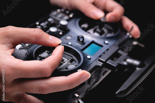 Konstfotografi female hands holding sticks on the remote control of a drone, close-up, indoors