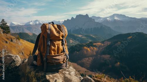 A backpack stands on a rock with mountain view background