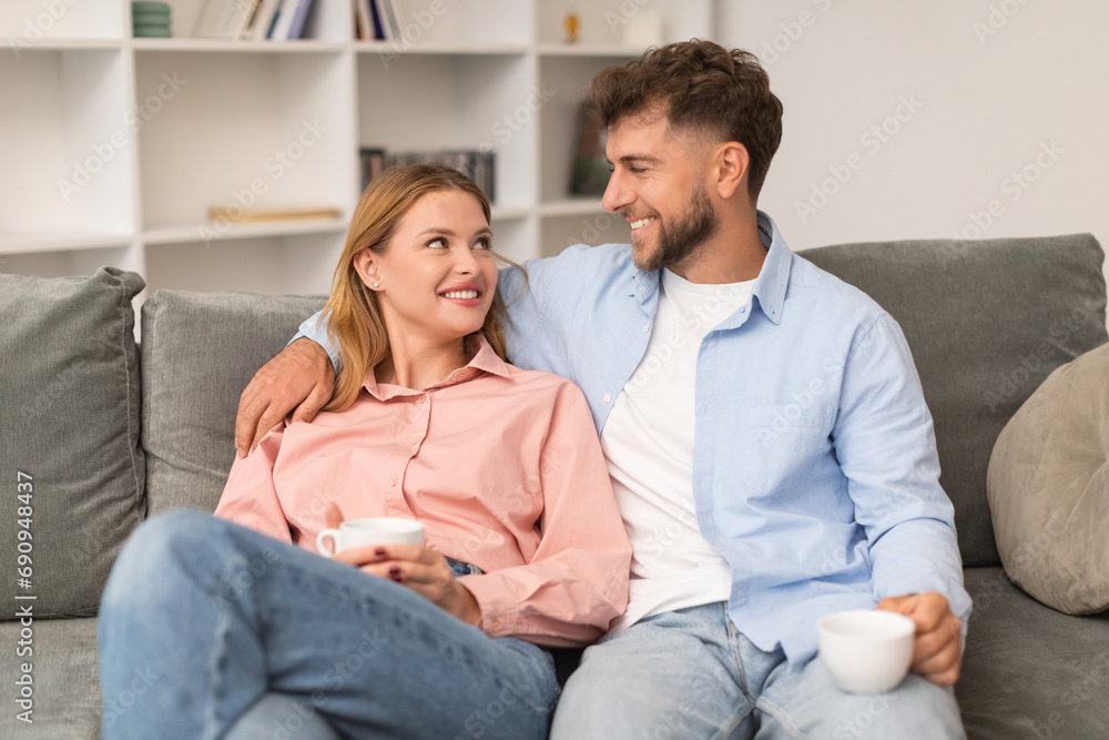 loving european young couple enjoying coffee together embracing at home loving european young couple enjoying coffee together embracing at home