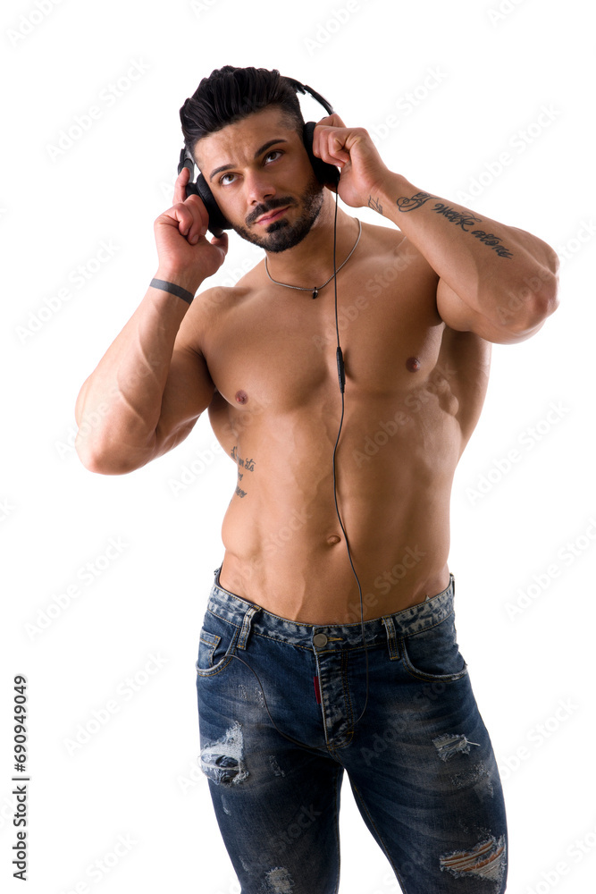 Fototapeta premium A shirtless man with headphones on his ears, isolated on white in studio shot