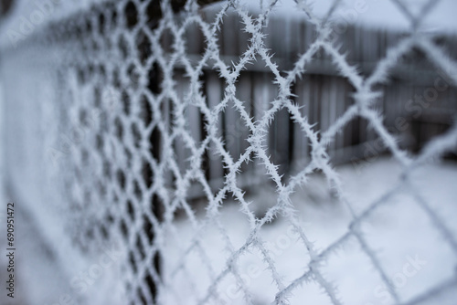 Frozen wired fence close up shot at a cold winter morning, copy space. photo