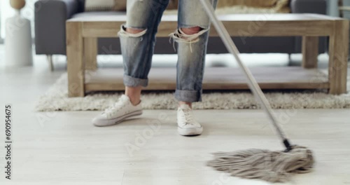 Person, legs and mop or cleaning floor for hygiene disinfection, dust maintenance or dirt task. Housekeeping, feet and equipment for maid service in house for wood ground, bacteria or germ removal photo
