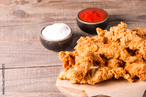 Crispy fried chicken breast strips with sauce
