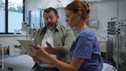 Female doctor consulting with overweight patient, discussing test result in doctor office. Obesity affecting middle-aged men's health. Concept of health risks of overwight and obesity.