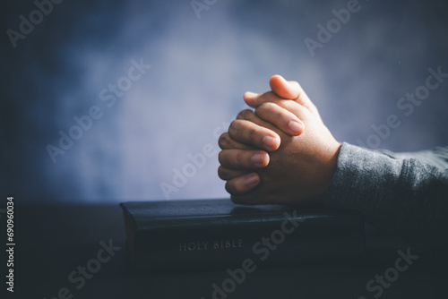 Christian life crisis prayer to god. Woman worship for god blessing to wishing have a better life. woman hands praying to god with the bible. begging for forgiveness and believe in goodness. photo