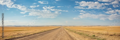 Panoramic view of farm land in North Eastern Colorado with a county gravel road near Sterling