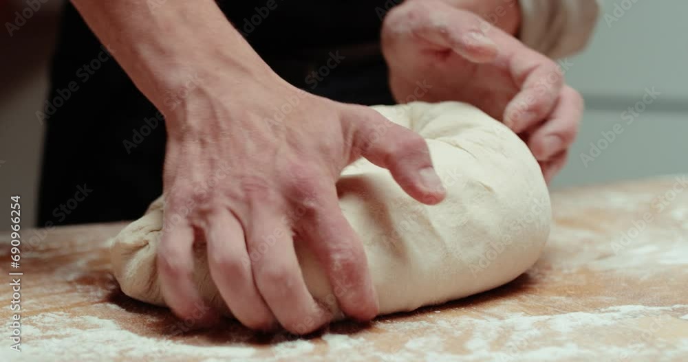Close up view of bakers hands kneading the dough on the table. Close up view of bakers hands kneading the dough on the table.