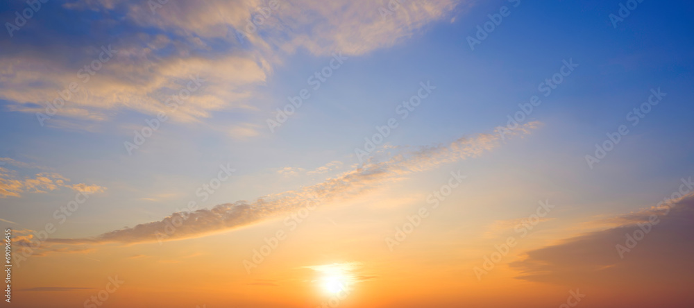 Sunrise sky in the morning with yellow sunlight and clouds on panoramic blue sky background