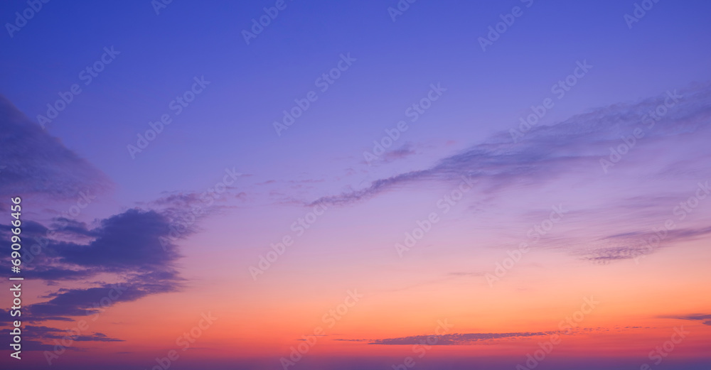 Evening sky with beautiful sunlight and silhouette fluffy clouds on colorful sunset sky twilight, Idyllic natural tranquil scene background