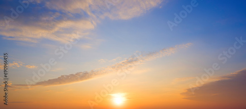 Sunrise sky in the morning with yellow sunlight and clouds on panoramic blue sky background © Prapat