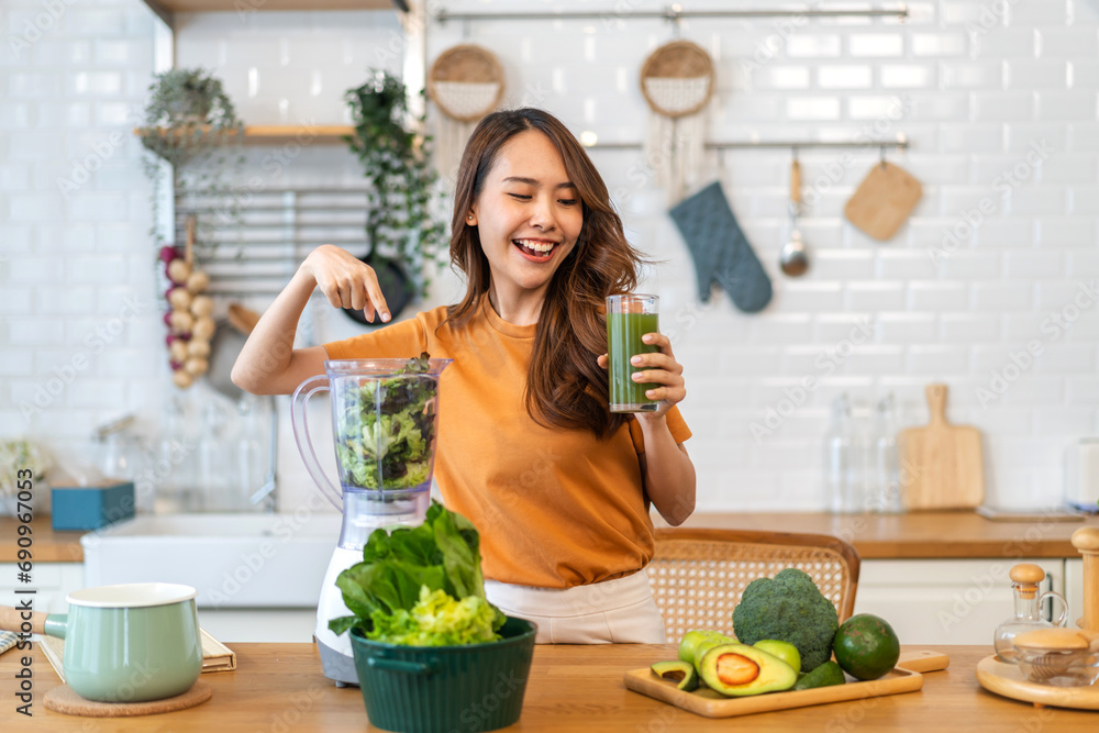 Portrait of beauty healthy asian woman making green vegetables detox cleanse and green fruit smoothie with blender.young girl drinking glass of smoothie, fiber, chlorophyll in kitchen.Diet, healthy. - obrazy, fototapety, plakaty 