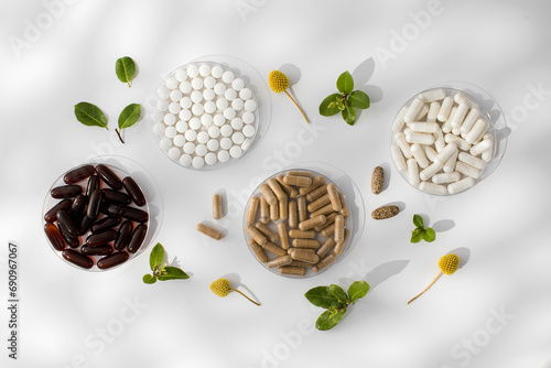Various vitamins, tablets and dietary supplements with natural formulations on a white background. photo