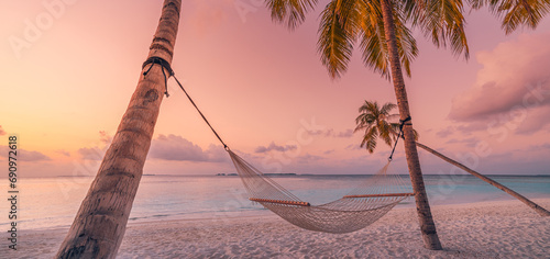 Fototapeta Naklejka Na Ścianę i Meble -  Relax vacation leisure lifestyle on exotic tropical island beach, palm tree hammock hanging calm sea. Paradise beach landscape panoramic sunrise sky clouds amazing reflections. Beautiful nature banner