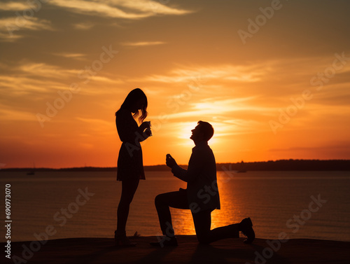A Couple Getting Engaged On A Beach At Sunset With The Proposal Happening In The Background