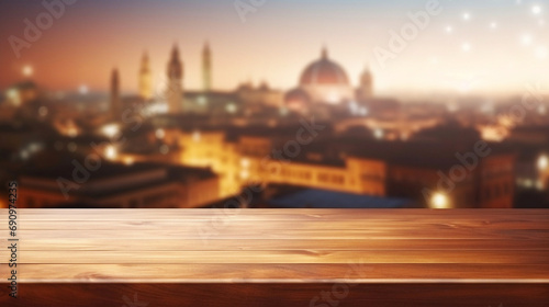 Empty wooden table with panoramic view at historic Middle Eastern city at night with arquitecture aglow with night lights. photo