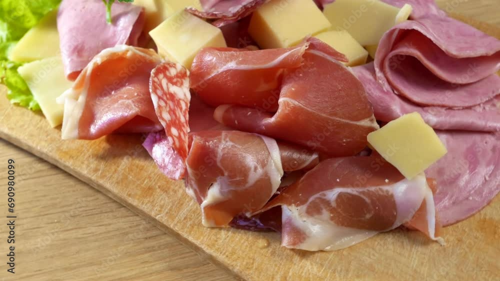 Cold Smoked Meat, jamon, sausage, cold meat, cheese. Plate, antipasto set platter wooden plate. Cold smoked meat plate with sliced ham, prosciutto, bacon Cold Smoked Meat, jamon, sausage, cold meat, cheese. Plate, antipasto set platter wooden plate. Cold smoked meat plate with sliced ham, prosciutto, bacon