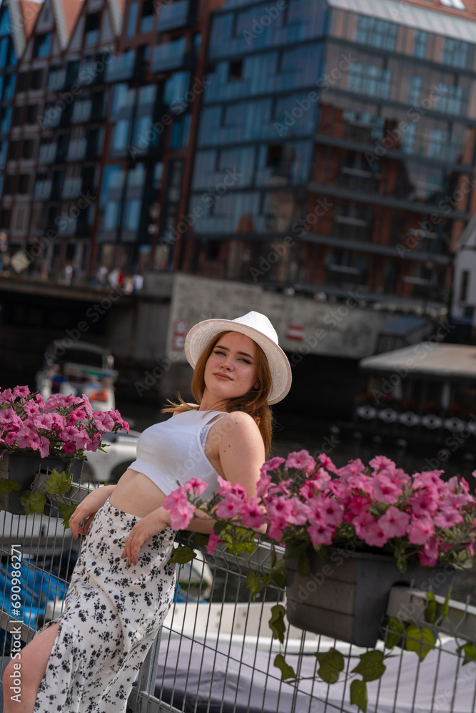 Fototapeta premium girl in a white hat on the background of the city of Gdansk Poland Europe