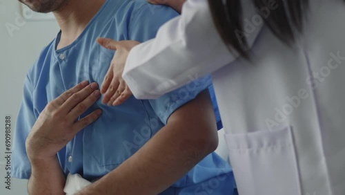 Doctor  listening lungs and test rise patient hand with chest pain and had a risk for heart attack in hospital.