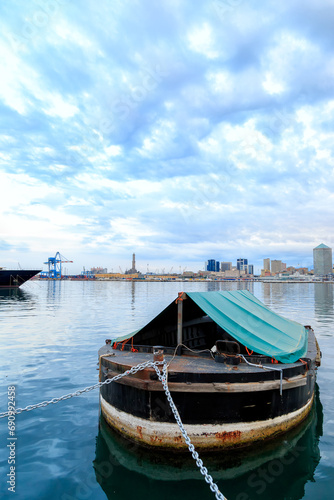 Genoa  Italy - July 11  2019  Old barge moored in the old port of Genoa