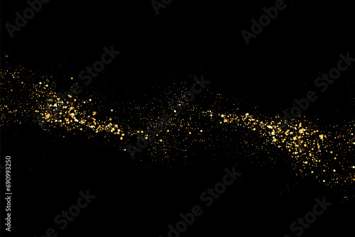 Scattered golden particles on a dark background. Festive background or design element.