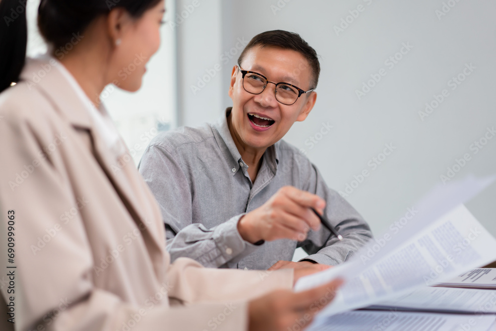 Senior businessman discussing and asking about terms of contract and legal agreement with lawyer Senior businessman discussing and asking about terms of contract and legal agreement with lawyer
