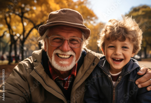 Happy American grandfather and kid in park. © visoot