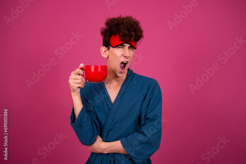 Retro style. A funny curly guy gets ready for his work day early in the morning. Pink background.