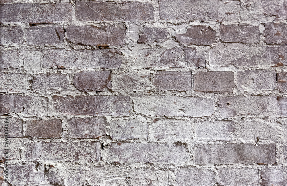 Fragment of an old wall with cracks and holes. Structure of an old wall. Architectural concept for repair, restoration and construction. Fragment of an old wall with cracks and holes. Structure of an old wall. Architectural concept for repair, restoration and construction.