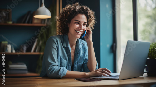 Woman in a casual outfit works on a laptop in her office