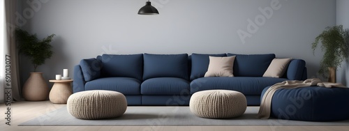 A dark blue corner sofa next to knitted puffs. Interior design of a modern living room in the Scandinavian style. photo