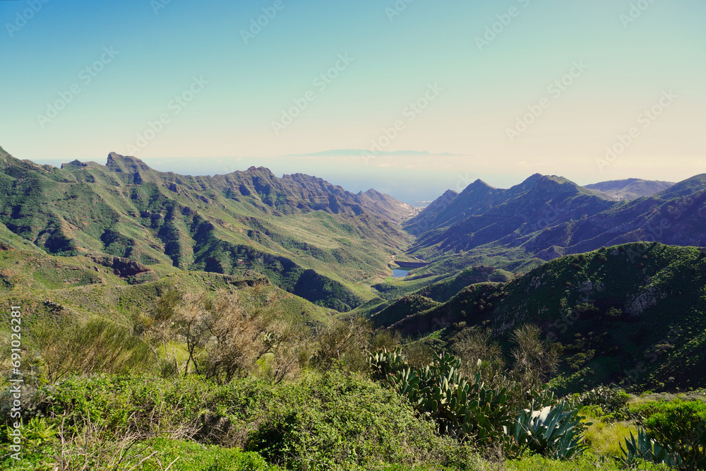 The Barranco de Tahodio is one of the great ravines of Anaga. Tenerie, Canary Islands. In the background the capital of the Island of Tenerife and its port