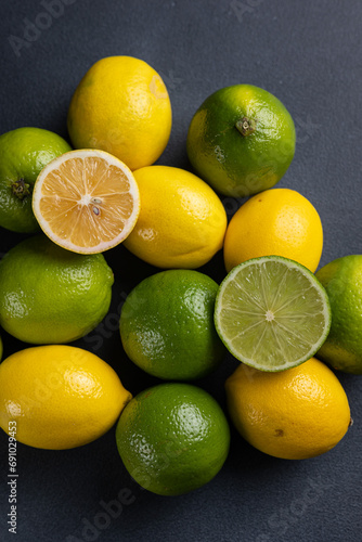 Limes and lemons on a dark background, close-up