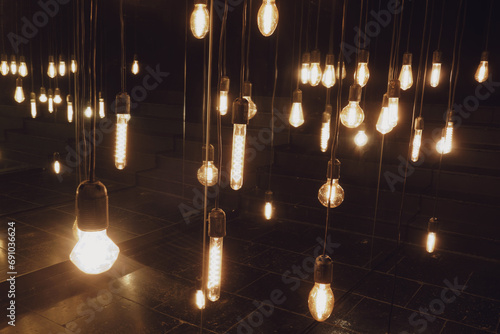 Incandescent light bulbs in a dark room. Lighting decor.