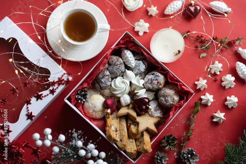 christmas star cookies and a cup of tea on a green background