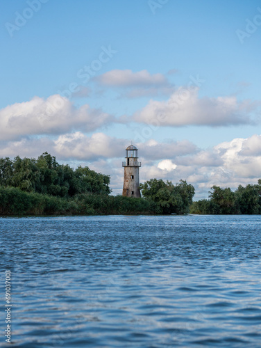 Old abandoned lighthouse on river close to sea