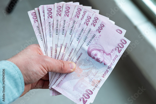 Man is holding Turkish money. 200 lira banknotes on his hand. photo