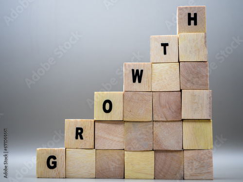 The word GROWTH written on wooden cubes on a gray background. photo